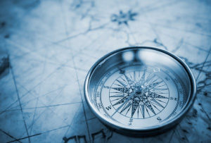 picture of a compass sitting on a map
