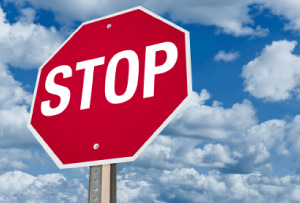 Picture of a red stop sign against a blue sky