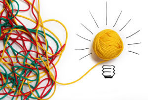 Photo of a confused mess of wool leading to a lightbulb, to symbolise career insight