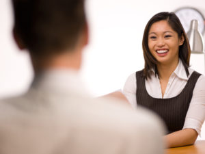 Picture of a woman smiling with confidence in a job interview
