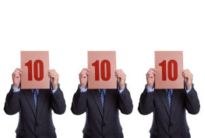 Picture of 3 men holding up signs awarding 10 out of 10